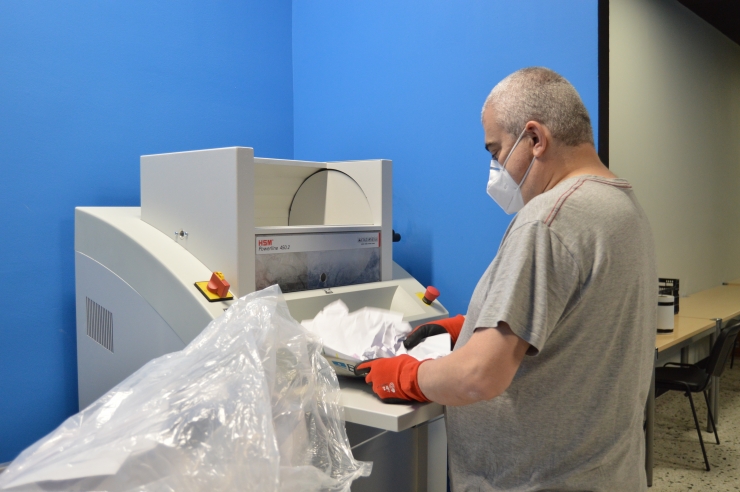 Un treballador de la línia de destrucció de documentació.