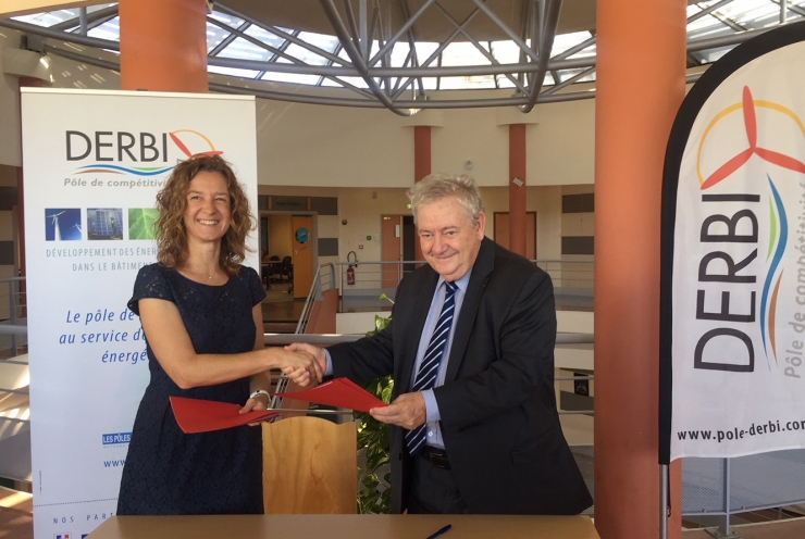 La ministra de Medi Ambient, Agricultura i Sostenibilitat, Sílvia Calvó, i el president del Pol de competitivitat pel desenvolupament de les energies renovables en l’edificació i la indústria (Derbi) de França, André Joffre, es donen la mà després de signar l'acord de col·laboració.